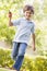 Young boy with toy airplane running outdoors