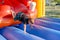 Young boy tumbling around on a jumping castle