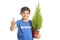Young boy volunteer with a plant making thumbs up