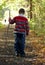 Young Boy Walking with Stick