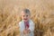 Young boy wearing traditional ukraine clothes in wheat