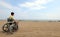 Young boy on a wheelchair looks at the sea