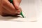 A young boy writing with green felt-tip pen a some word on english lesson at elementary school