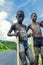 Young Boys of Benna Tribe with Traditional Body Painting on the Long Wooden Sticks posing for the picture