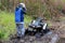 A young boys holds his helmet looking at his stuck quad