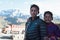 Young boys of Kargil, India posing for a photograph with Himalayan mountains behind him