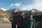 Young boys of Kargil, India posing for a photograph with Himalayan mountains behind him