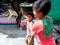 Young boys in a market in cainta, rizal, philippines selling fruits and vegetables