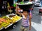 Young boys in a market in cainta, rizal, philippines selling fruits and vegetables