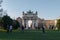 Young boys playing football in front of the Triumphal arch Arch of Peace in Milan