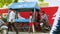 Young boys playing hand table tennis in ironing cart and one children practice shots on cricket and looking at camera