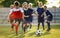 Young boys playing soccer training game. Junior football practice competition between players running in a duel and kicking ball