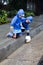 Young boys playing with toy boat in the rain 1