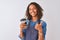 Young brazilian barista woman drinking take away coffee over isolated grey background happy with big smile doing ok sign, thumb up