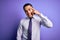 Young brazilian businessman wearing elegant tie standing over isolated purple background Smiling pointing to head with one finger,