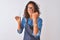 Young brazilian hairdresser woman using scissors standing over isolated white background annoyed and frustrated shouting with