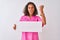 Young brazilian nurse woman holding banner standing over isolated white background annoyed and frustrated shouting with anger,