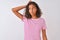 Young brazilian woman wearing pink striped t-shirt standing over isolated white background confuse and wonder about question