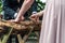Young bridal couple groom bride sawing a tree trunk together german wedding tradition