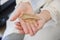 Young bride hands holding a piece of hair ornament shape as a golden w