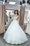Young bride making selfie in wedding dress in salon