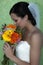 Young bride profile holding flowers