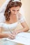 Young bride signing wedding documents