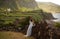 Young bride in white wedding dress on background of beautiful view of Flores island, Azores