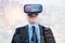 Young bristled man in VR headset looking up