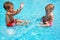 Young brother and sister playing in pool