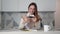 Young brown-haired woman having fun playing phone. Stock footage. Stylish young woman fun and enthusiastically playing