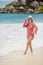 Young brunette bikini model posing on the beach