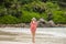 Young brunette bikini model posing on the beach