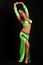 Young brunette in a green suit oriental dance