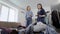 Young brunette and her stylist are checking and sorting wardrobe in home, applying clothes