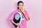 Young brunette nutritionist woman holding scale covering mouth with hand, shocked and afraid for mistake