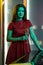 Young brunette standing with glass of champagne in subdued color lighting in home kitchen