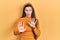 Young brunette teenager wearing casual yellow sweater moving away hands palms showing refusal and denial with afraid and