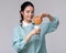 Young brunette wetting a cookie in a glass of milk