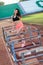 Young brunette woman athlete on stadium sporty lifestyle standing on track posing near the barriers running jumping to camera