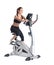 Young brunette woman on bike exerciser