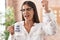 Young brunette woman drinking from i am the boss coffee cup annoyed and frustrated shouting with anger, yelling crazy with anger