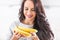 Young brunette woman holding a bunch of bananas