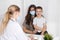 Young brunette woman with little boy having consultation at pediatrician office. Doctor, child and mother wearing