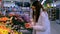 Young brunette woman in a medical mask chooses apples shop. Buying food