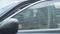 Young brunette woman putting on protective mask, closing side window, and getting out of the car. Portrait of anxious