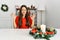 Young brunette woman sitting on the table on christmas relax and smiling with eyes closed doing meditation gesture with fingers