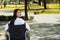 Young brunette woman sitting in wheelchair smiling with positive attitude, outdoors environment, physical recovery