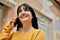 Young brunette woman smiling happy speaking on the phone at the city