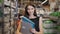 Young brunette woman, student, trainee or employee, smiling while choosing the right book or file from the office in